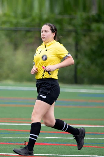 A referee running the line during a match